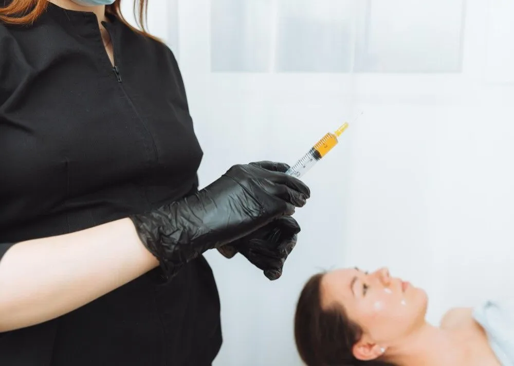 Hands cosmetologist collect plasma into syringe injection plasmolifting 1