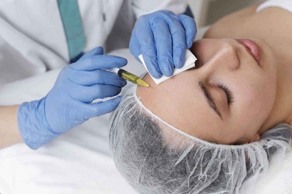 woman getting face prp treatment high angle